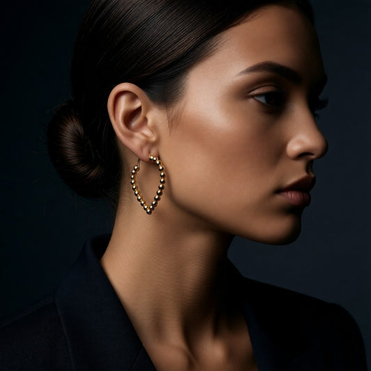 Aramat Jewels gold-tone stainless steel teardrop hoop earrings with a beaded design, 33mm.