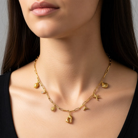 Aramat Jewels gold-tone stainless steel necklace with multiple charms including a pearl, dolphin, sun, shell, starfish, and turtle.