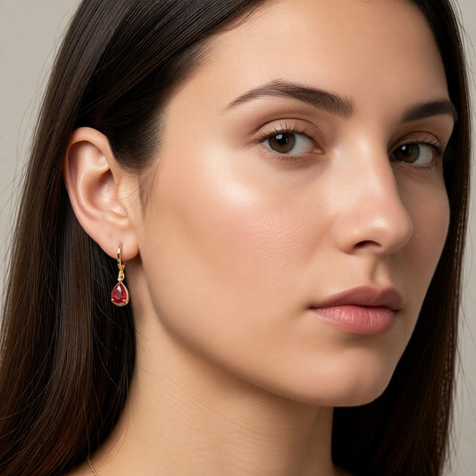 Aramat Jewels gold-colored mini hoop earrings with a red teardrop zirconia stone, designed for girls.