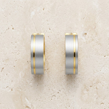 Aramat Jewels bicolor stainless steel hoop earrings with a matte silver finish and a gold stripe detail, 13mm.
