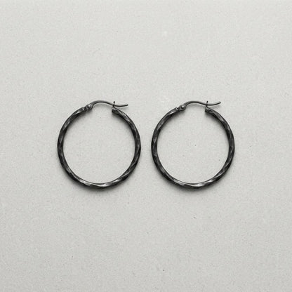 Aramat Jewels black twisted stainless steel hoop earrings, 40mm diameter, high gloss finish, statement jewelry for women.