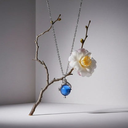 Aramat Jewels silver-colored stainless steel teardrop ash pendant with blue zirconia, 31x18mm, for ashes or hair.
