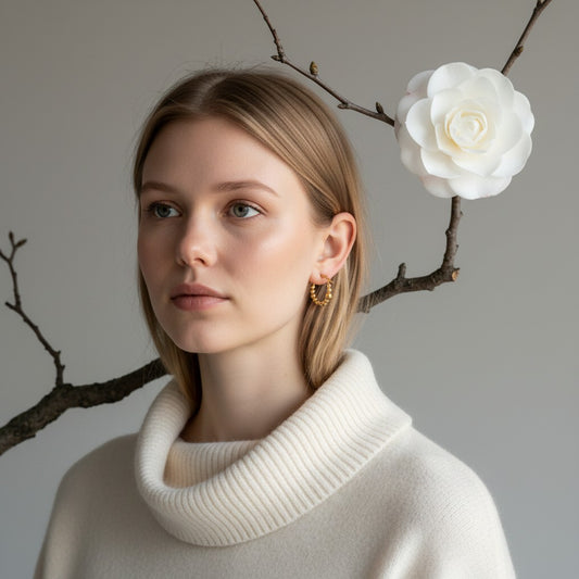 Aramat Jewels gold-coloured 21mm hoop earrings with a beaded motif, worn by a blonde model.