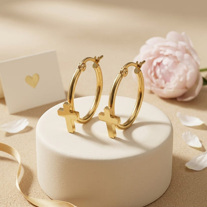 Aramat Jewels gold-tone stainless steel hoop earrings with dangling cross charms, 25mm diameter.