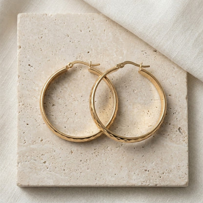 Aramat Jewels gold-tone stainless steel hoop earrings with a checkered pattern, 35mm diameter.