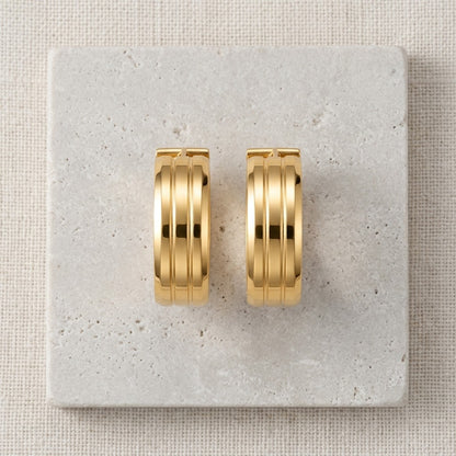 Aramat Jewels gold-tone stainless steel hoop earrings with double stripe detail, 13mm or 20mm diameter.