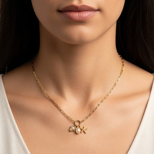 Aramat Jewels gold-tone stainless steel necklace with interchangeable charms: pearl, hamsa hand, and starfish. 45cm length.