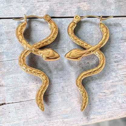 Aramat Jewels gold-tone stainless steel snake hoop earrings with textured scales, 42x17mm.