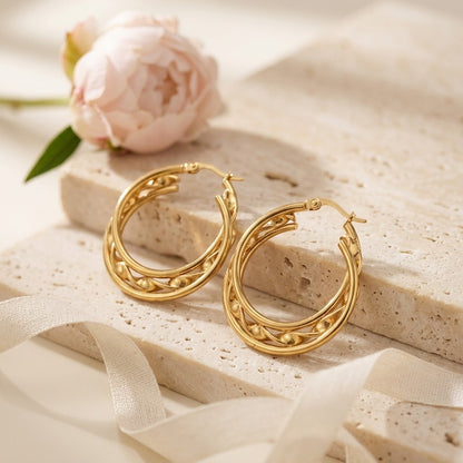 Aramat Jewels gold-tone stainless steel triple hoop earrings with a twisted design and beaded accents, 25x7mm.