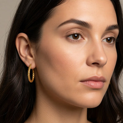 Aramat Jewels gold-tone stainless steel hoop earrings with a twisted rope design, 30mm diameter.