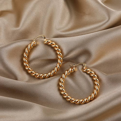 Aramat Jewels gold-tone stainless steel hoop earrings with a double twisted rope design, 30mm diameter.