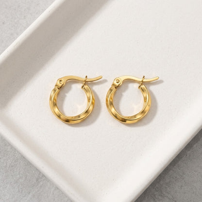 Aramat Jewels gold-tone stainless steel twisted hoop earrings, 10mm diameter, 2mm width, with hinge closure.