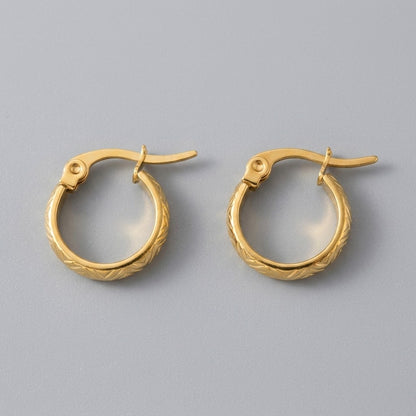 Aramat Jewels small gold-tone stainless steel hoop earrings with a textured zigzag pattern and hinge closure.