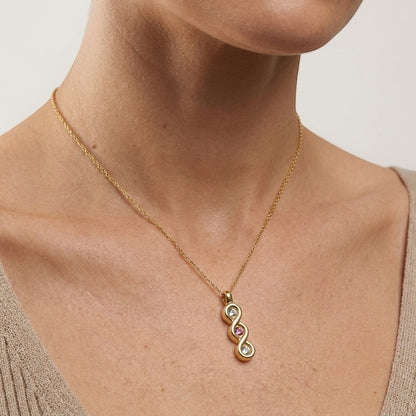 Aramat Jewels® goudkleurige stalen ashanger met zirkonia en roze steen, zonder ketting.