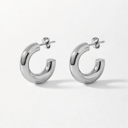 Aramat Jewels massieve zilverkleurige halve oorringen van glad RVS, 25x8mm, voor een moderne look.