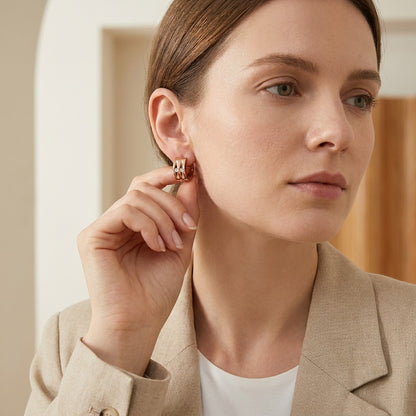 Aramat Jewels rose gold huggie earrings with two clear cubic zirconia stones, 13mm diameter.