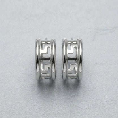 Aramat Jewels silver-tone stainless steel hoop earrings with a cut-out Greek key pattern, 20mm diameter.