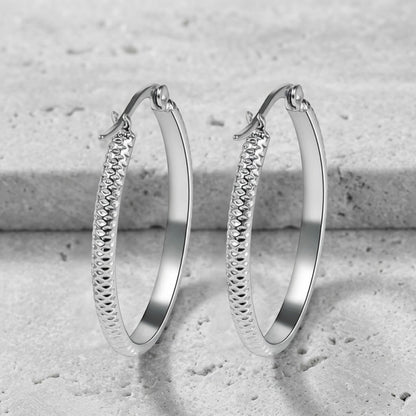 Aramat Jewels silver-tone stainless steel 35mm hoop earrings with a textured dot pattern. These women's earrings are sleek and modern.