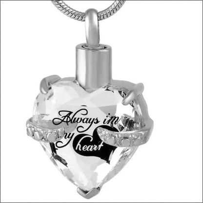 Aramat Jewels zilverkleurige hart crematiehanger van 316L staal met zirkonia en gravure 'Always in my heart'.