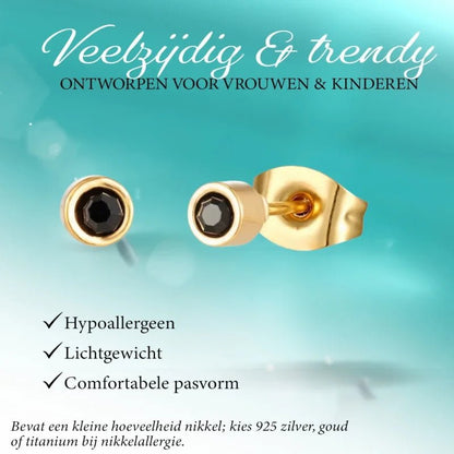 Gouden oorbellen met zwarte stenen.