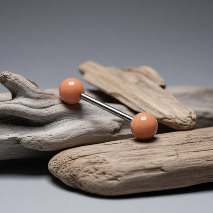 Aramat Jewels steel tongue barbell with a peach pearl ball. Hypoallergenic and suitable for healed piercings.